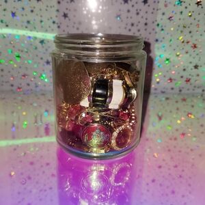 Assorted Gold and Pink Jewelry in Jar